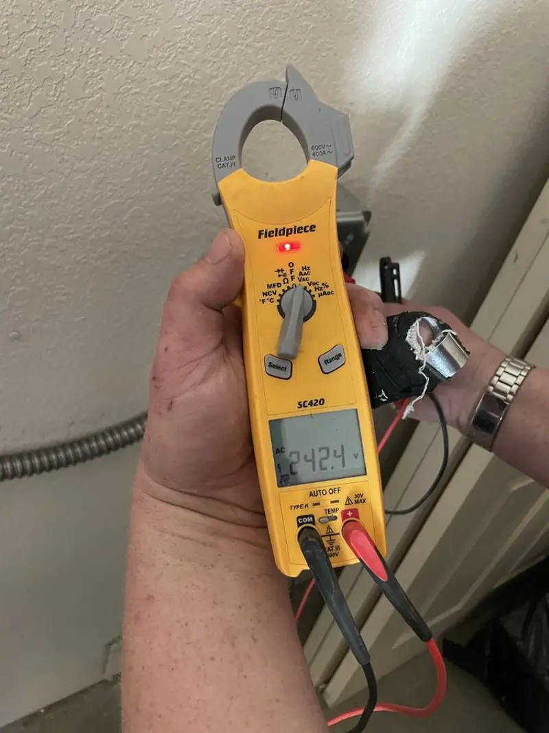 Voltage testing with clamp meter during Ceiling Fan Installation in Glenmont